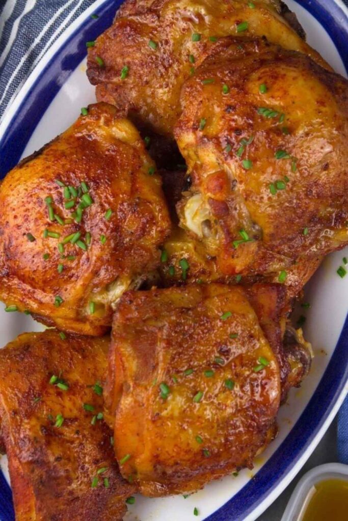 Golden brown chicken thighs on plate